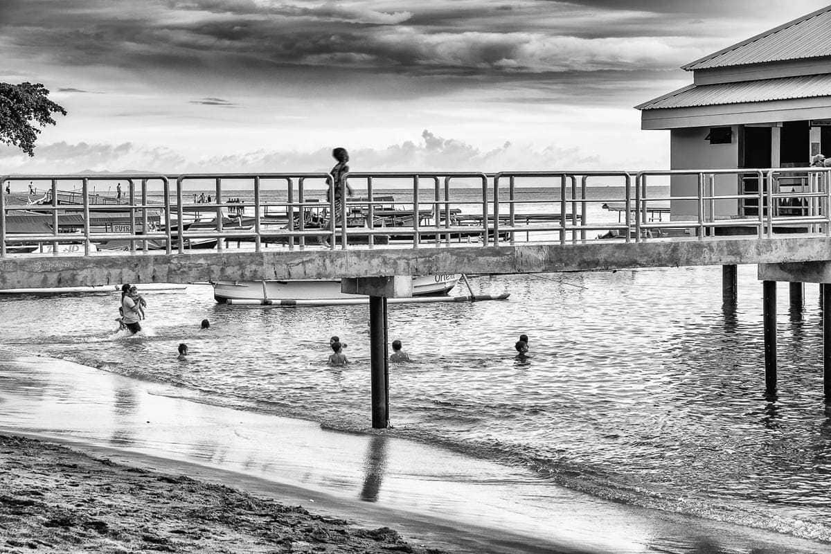 Swimming running Senggigi Pier Lombok Island Indonesia