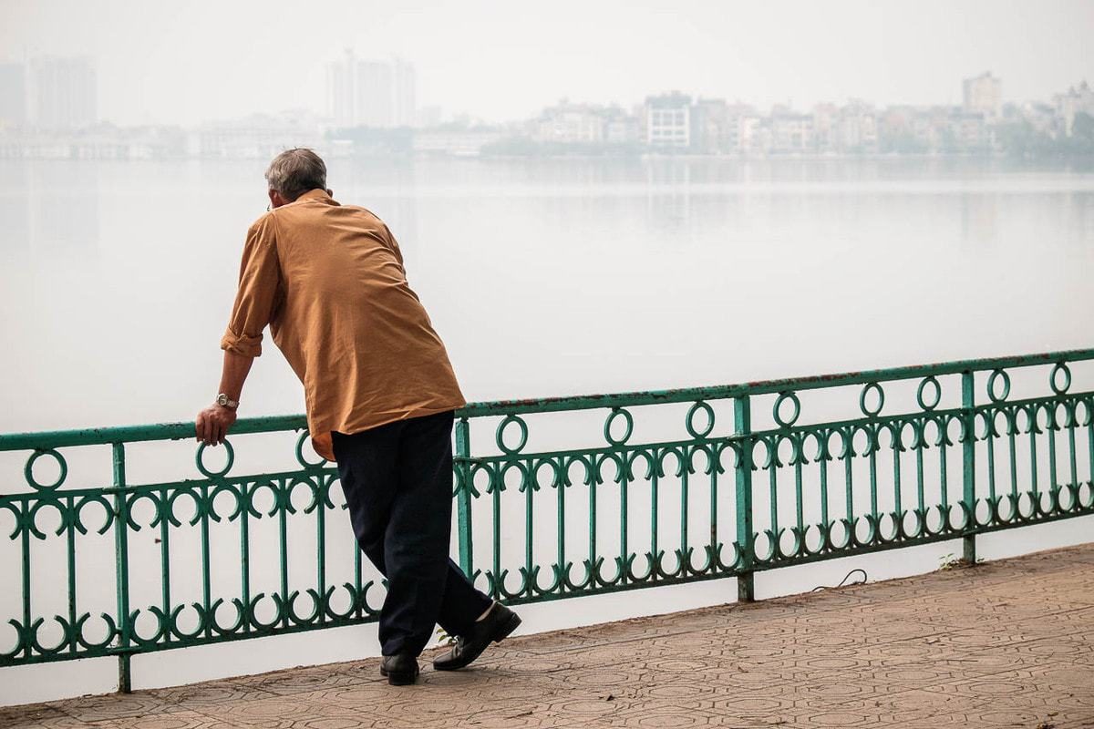 Vietnamese man looks Ho Tay West Lake Hanoi Vietnam