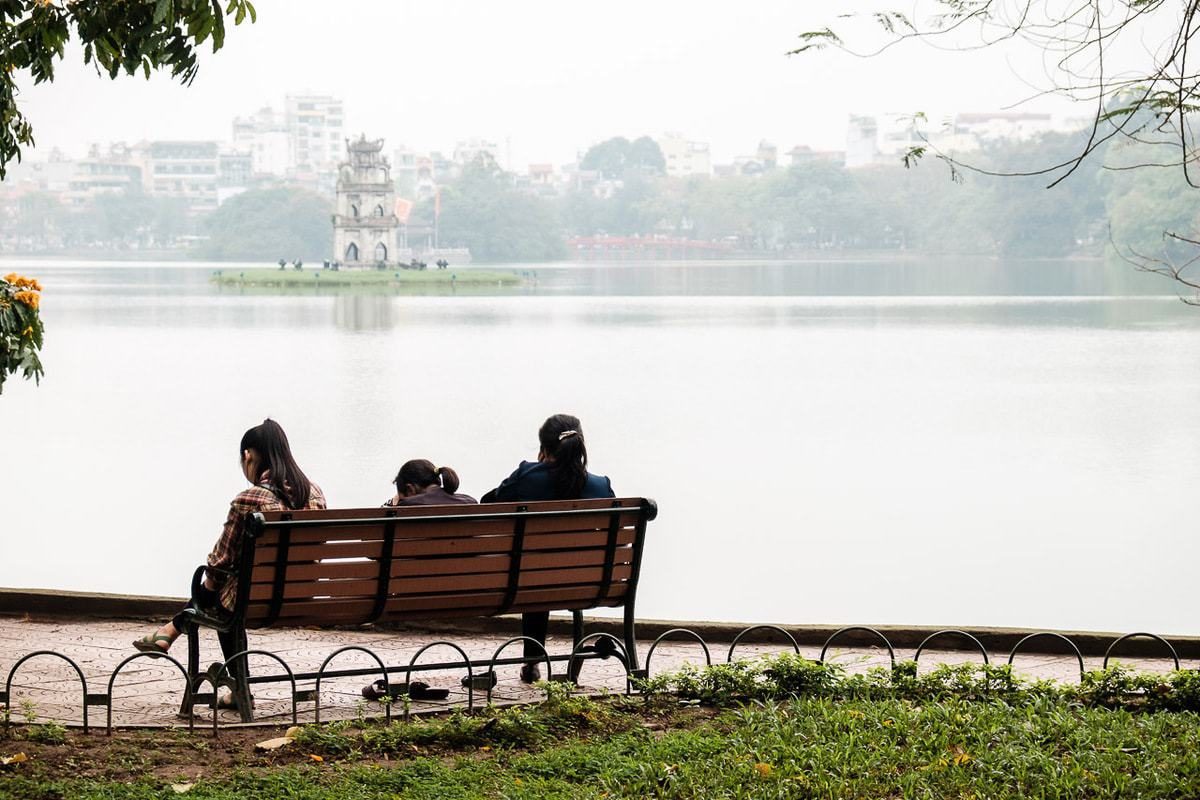 People seat bench Hoan Kiem Lake Hanoi Vietnam