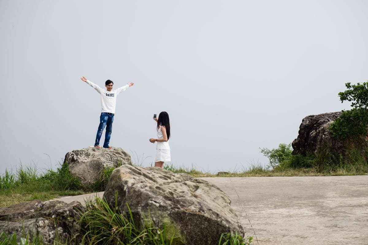 Young Khmer couple enjoys the foggy day at Bokor Mountain. Kampot, Cambodia.