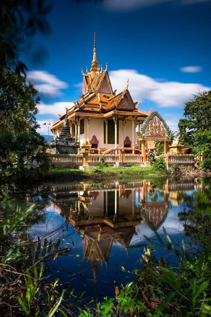 Colourful Buddhist temple by the Kampot River. Kampot, Cambodia.
