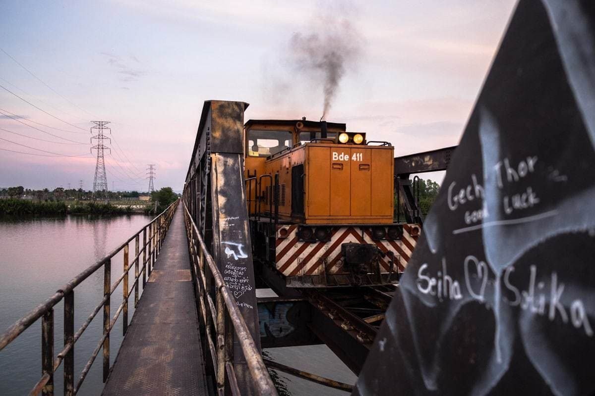 A freight train on the railway bridge over the Kampot River. Kampot, Cambodia.