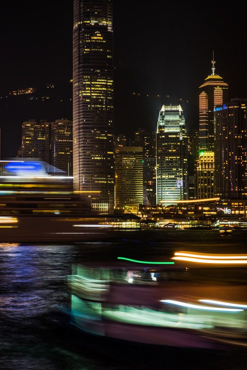 Boats come and go at Victoria Harbour by night. Hong Kong Island, Hong Kong.
