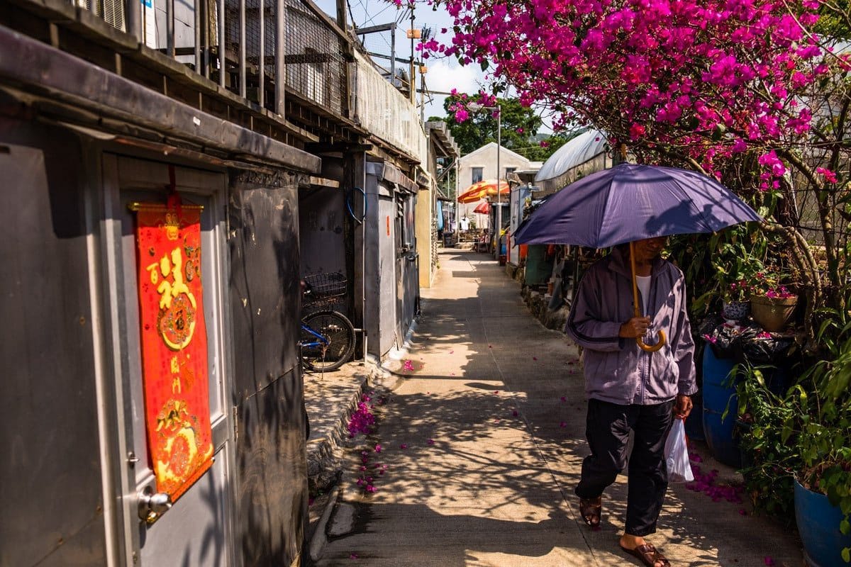 Man with umbrella. The fishing village Tai O. Lantau Island, Hong Kong.