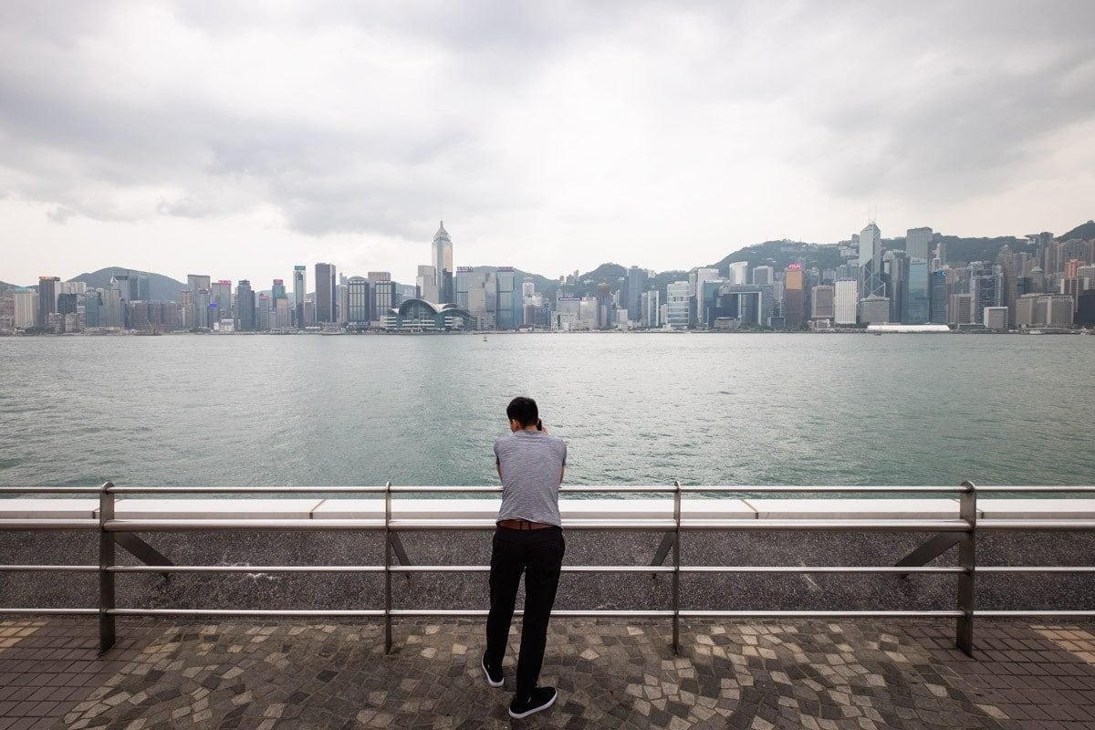 Man on the phone at Victoria Harbour. Hong Kong.