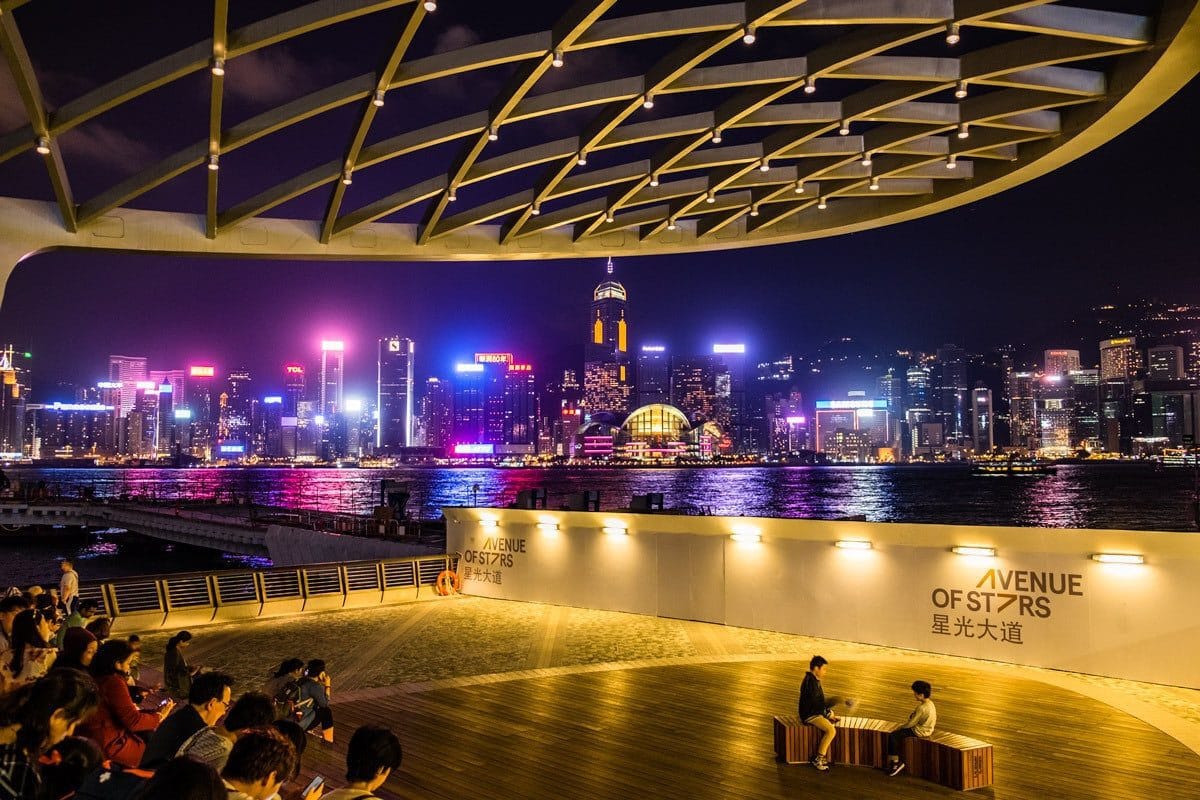 The Avenue of Stars by night. Victoria Harbour waterfront in Tsim Sha Tsui, Hong Kong.