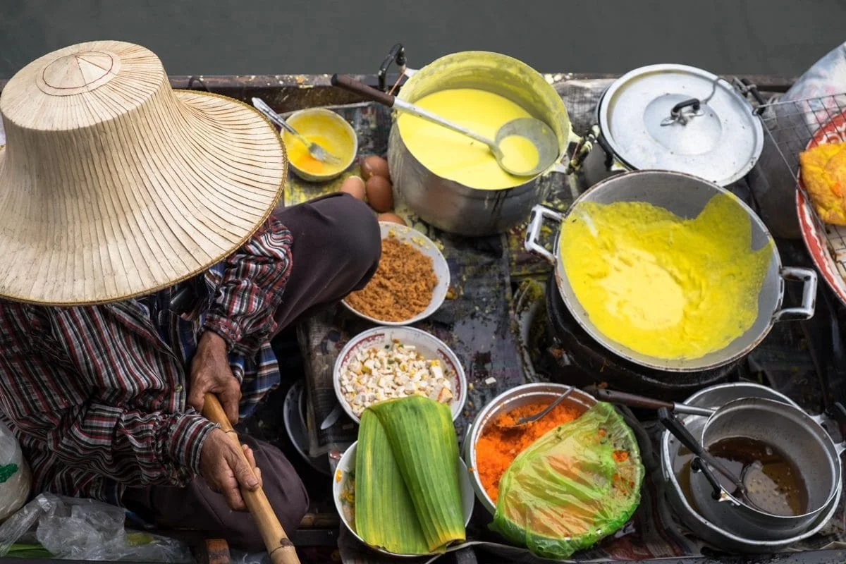 Close up of a Thai snack vendor on a boat.