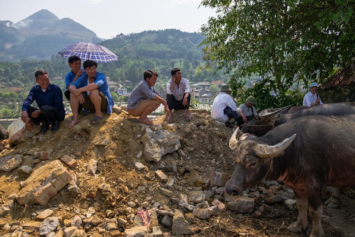 Vietnamese Hill Tribe H'Mong men have a rest at Bac Ha market.