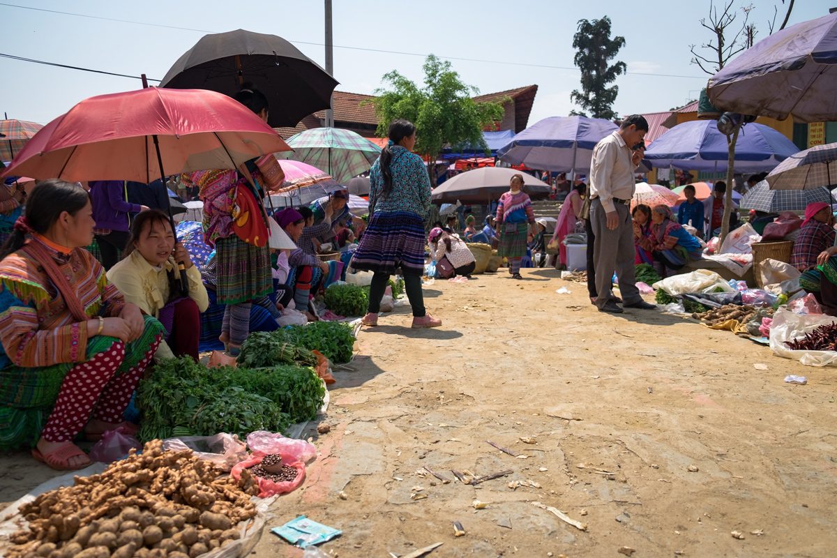 Vietnamese H'Mong women sell fruits and vegetables at Bac Ha Market in Northern Vietnam.