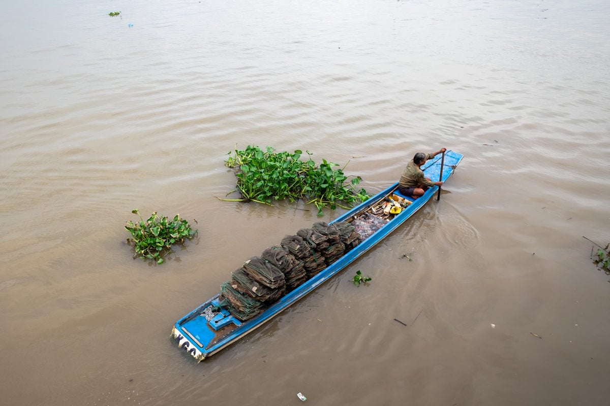 Vietnamese fisherman on his boat is ready to go to set his fishing nets. Mekong Delta. Can Tho, Vietnam.