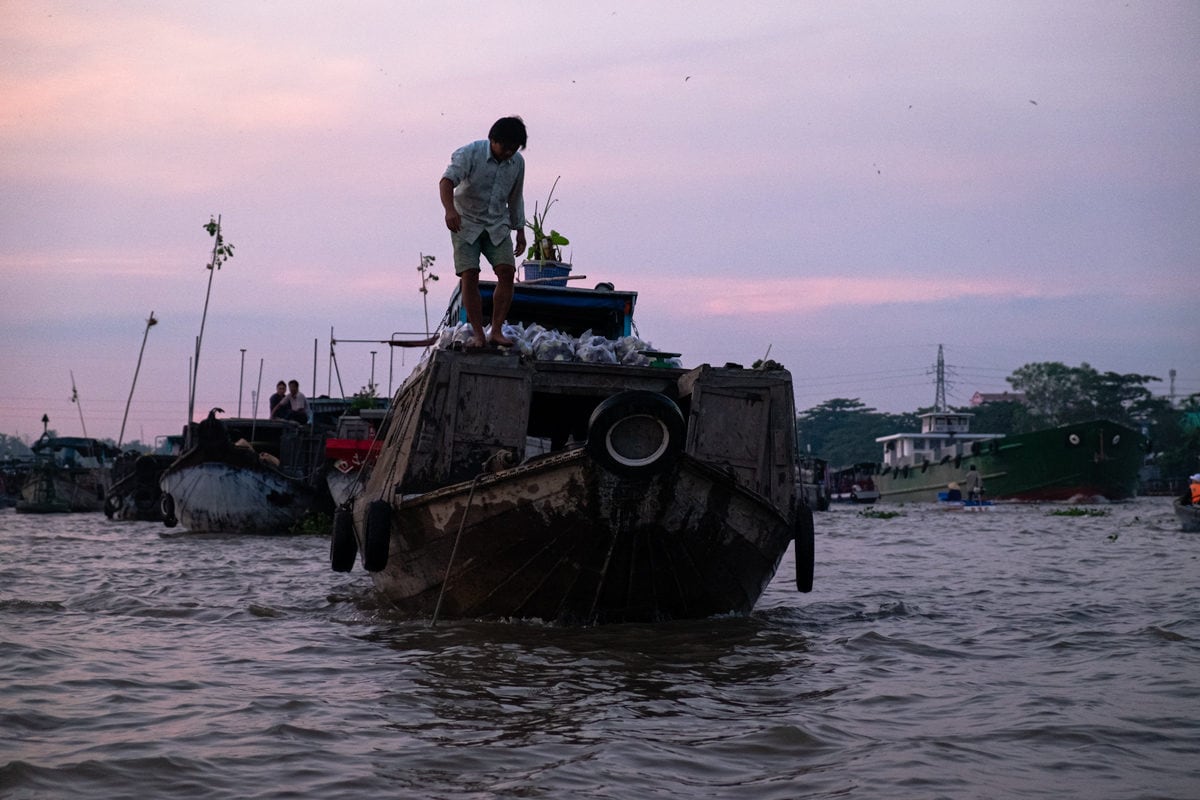 Vietnamese veg seller on his boat at Cai Rang floating market on the Mekong Delta. Can Tho, Vietnam.