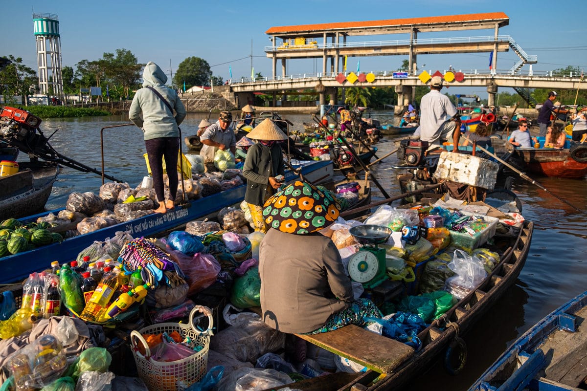Vietnamese grocery sellers sit on their boats on Phong Dien floating market. Mekong Delta, Can Tho, Vietnam.