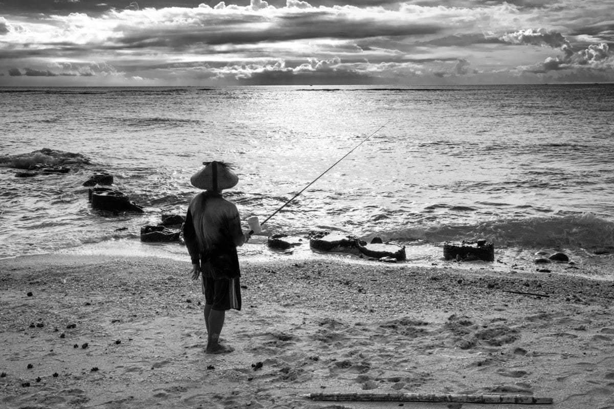 Fisherman at Senggigi Beach. Lombok Island, Indonesia.