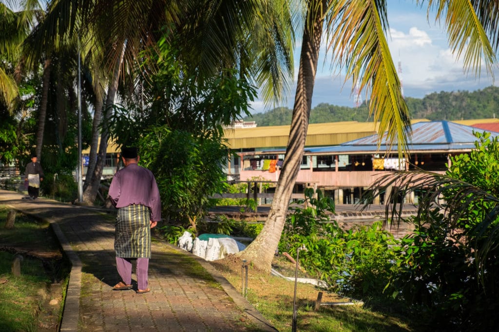 Bruneian people go for a walk in Kampong Ayer, or the Water Village on the Brunei River. Bandar Seri Begawan, Brunei.