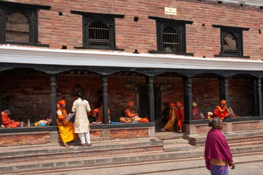 Elderly women seat outside the Pashupati Briddhashram in the outer complex of Pashupatinath Temple in Kathmandu, Nepal.