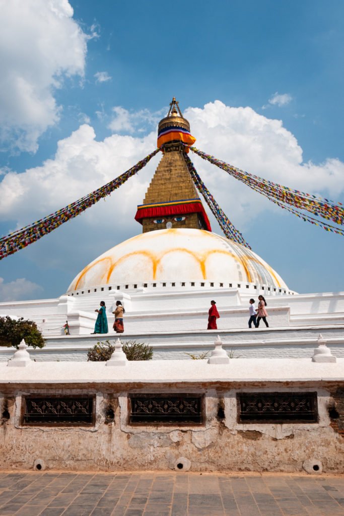 Nepalese people walk at Boudhanath Stupa in Kathmandu, Nepal.