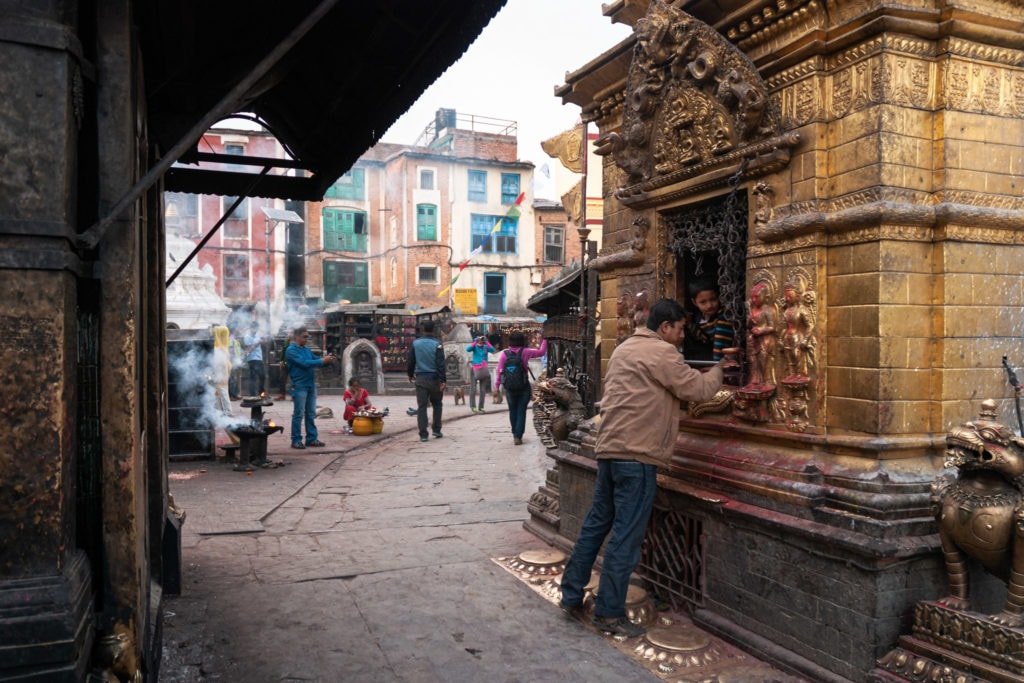 Nepalese child in a shrine at the Swayambhunath (Monkey Temple) complex in Kathmandu, Nepal.