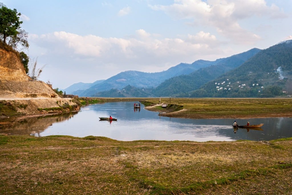 Simple cable ferry and canoes on Phewa lake. Pokhara, Nepal.