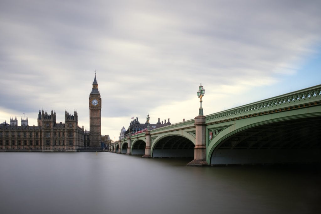 Westminster Bridge with the Palace of Westminster and the Big Ben. London, Uk. Because of the long exposure water and clouds look smooth and silky, and people look ghostly almost disappeared.