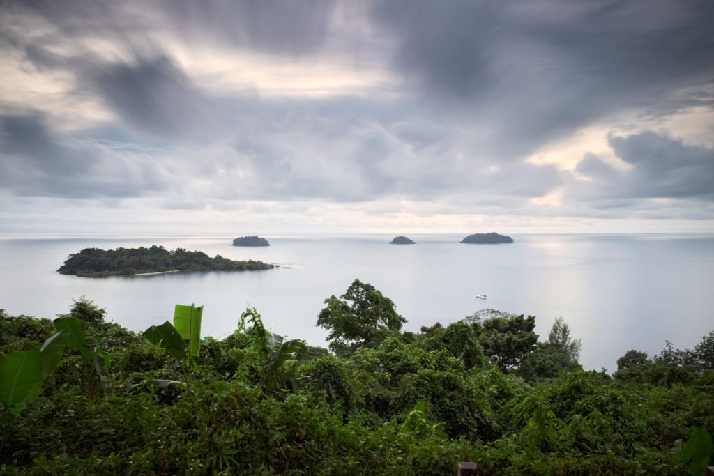 Long exposure taken from a high Seaview Point at Kaibae beach on Koh Chang island, Thailand. Clouds and sea look creamy. The 4 small islands near the horizon starting from the left are Koh Man Nai, Koh Man Nok, Koh Man Pli and Koh Man Yuak.