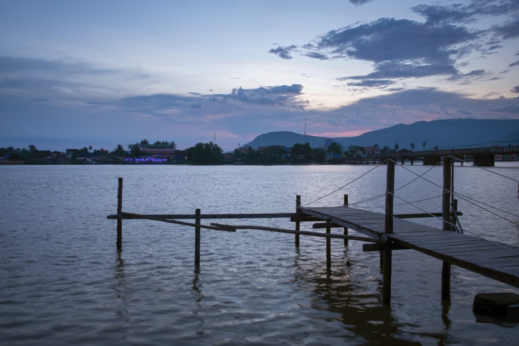 Wooden pier on Kampot River in twilight. Kampot, Cambodia.