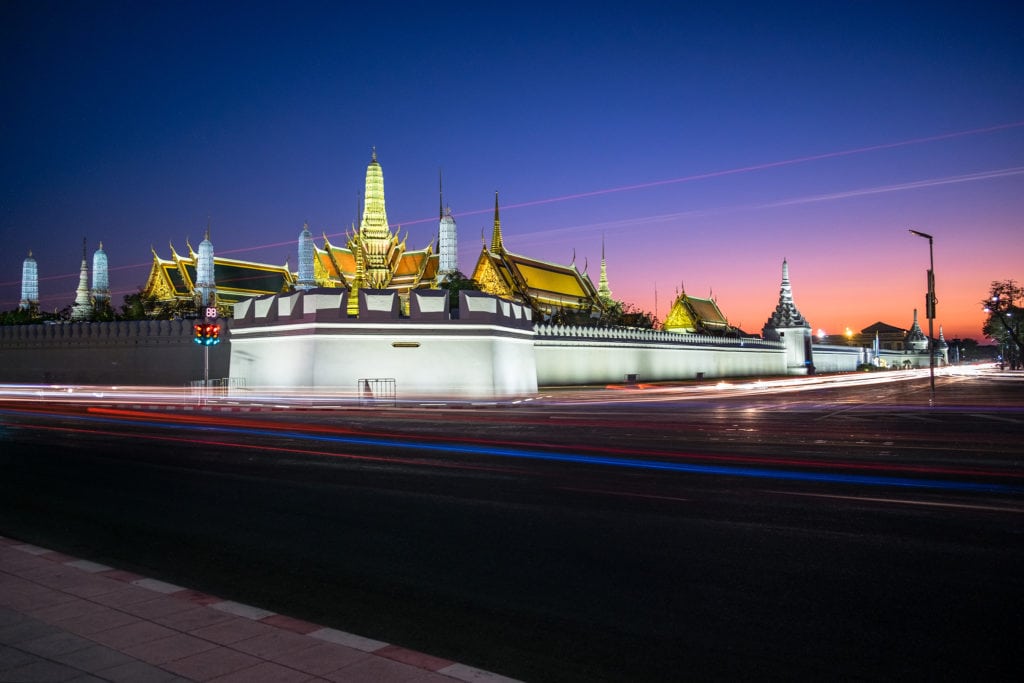 Light trails from cars in front of the Grand Palace in twilight. Bangkok, Thailand.